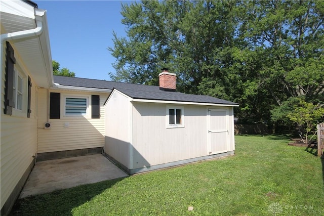 412 Cedar Ln, Lebanon, OH 45036 - view of property exterior with a lawn, a storage unit, a chimney, and a shingled roof