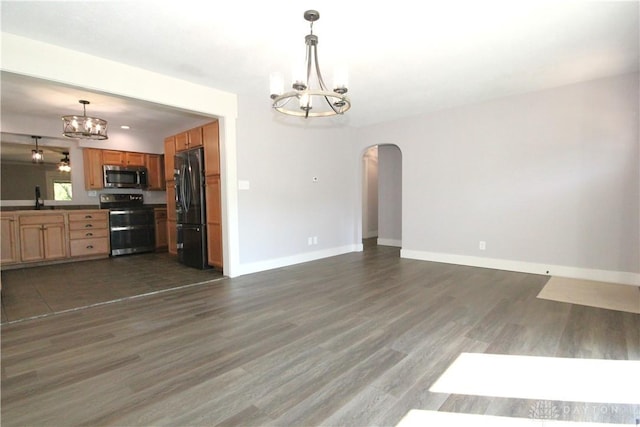 412 Cedar Ln, Lebanon, OH 45036 - kitchen with stainless steel appliances, a chandelier, arched walkways, dark wood finished floors, and open floor plan