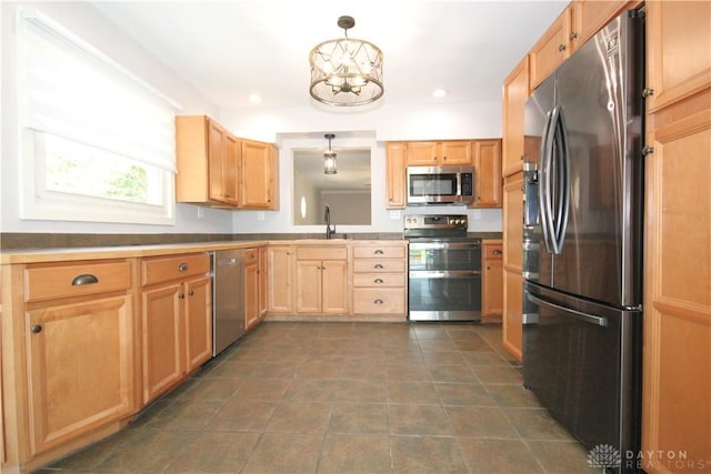 412 Cedar Ln, Lebanon, OH 45036 - kitchen with stainless steel appliances, light brown cabinets, a chandelier, decorative light fixtures, and recessed lighting