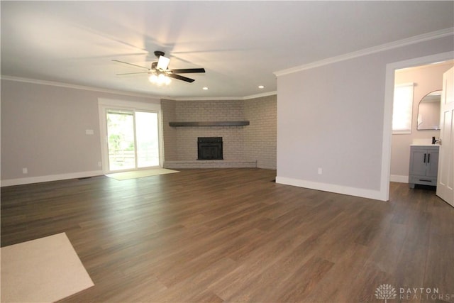 412 Cedar Ln, Lebanon, OH 45036 - unfurnished living room featuring a ceiling fan, crown molding, a fireplace, wood finished floors, and recessed lighting