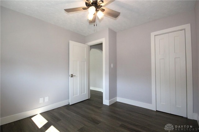 412 Cedar Ln, Lebanon, OH 45036 - unfurnished bedroom featuring dark wood finished floors, a textured ceiling, a ceiling fan, and a closet