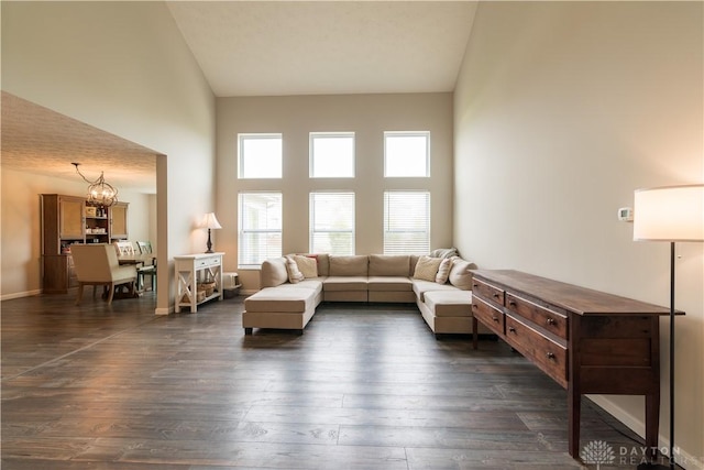 4005 Clearstream Way, Englewood, OH 45322 - living area featuring a chandelier, a towering ceiling, and dark wood-style flooring