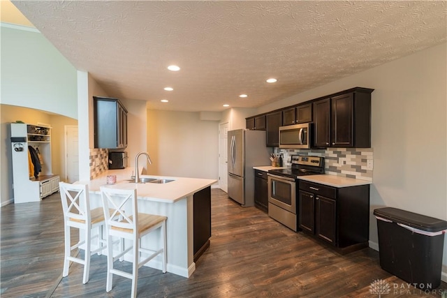 4005 Clearstream Way, Englewood, OH 45322 - kitchen with appliances with stainless steel finishes, tasteful backsplash, dark wood-style flooring, light countertops, and dark brown cabinets