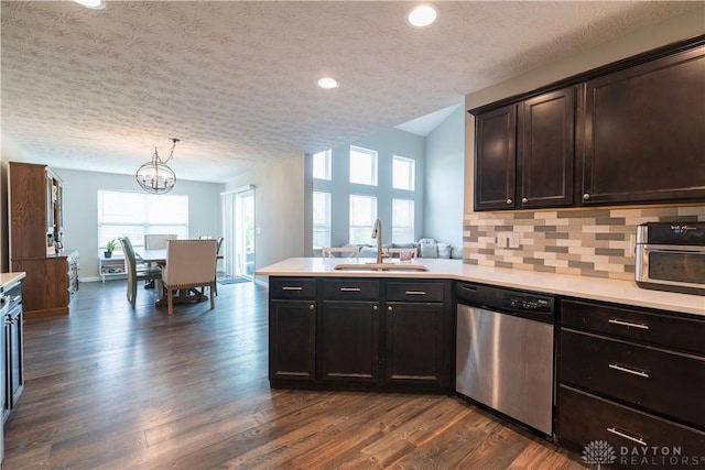 4005 Clearstream Way, Englewood, OH 45322 - kitchen featuring stainless steel dishwasher, light countertops, a peninsula, a textured ceiling, and decorative backsplash