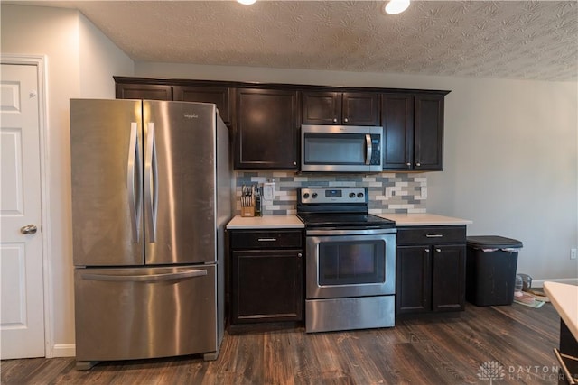 4005 Clearstream Way, Englewood, OH 45322 - kitchen featuring stainless steel appliances, dark wood finished floors, light countertops, a textured ceiling, and decorative backsplash