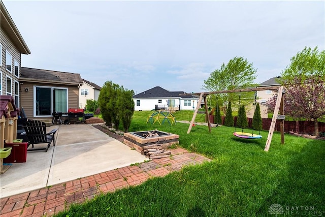 4005 Clearstream Way, Englewood, OH 45322 - fenced backyard featuring a playground, a fire pit, and a patio area