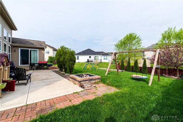 4005 Clearstream Way, Englewood, OH 45322 - fenced backyard featuring a fire pit, a patio area, and a playground