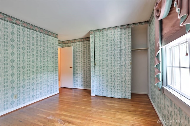 798 Carini Ln, Cincinnati, OH 45218 - unfurnished room featuring wood finished floors and wallpapered walls