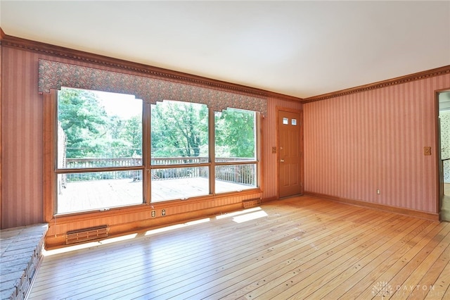 798 Carini Ln, Cincinnati, OH 45218 - spare room with light wood-style flooring, plenty of natural light, crown molding, and wallpapered walls