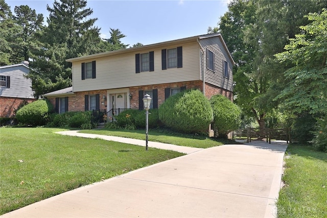 798 Carini Ln, Cincinnati, OH 45218 - view of front of property featuring brick siding, a front lawn, and concrete driveway