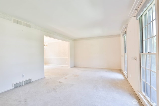 798 Carini Ln, Cincinnati, OH 45218 - empty room with carpet flooring, healthy amount of natural light, and a chandelier