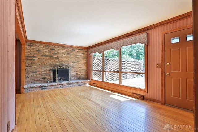 798 Carini Ln, Cincinnati, OH 45218 - unfurnished living room with hardwood / wood-style floors, a fireplace, and ornamental molding
