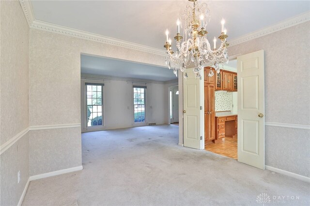 798 Carini Ln, Cincinnati, OH 45218 - unfurnished room featuring light colored carpet, ornamental molding, wallpapered walls, and a chandelier