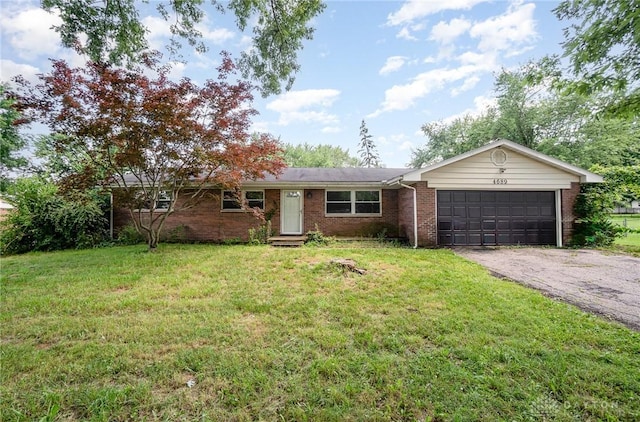 4689 Fisher Rd, Franklin, OH 45005 - ranch-style home featuring an attached garage, brick siding, driveway, and a front yard
