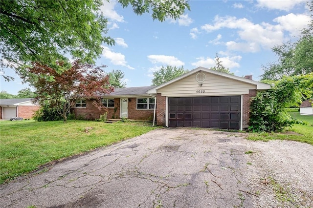 4689 Fisher Rd, Franklin, OH 45005 - single story home with brick siding, driveway, an attached garage, and a front lawn
