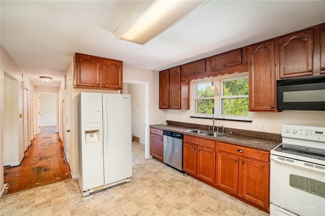 4689 Fisher Rd, Franklin, OH 45005 - kitchen with white appliances, light floors, dark countertops, and brown cabinets