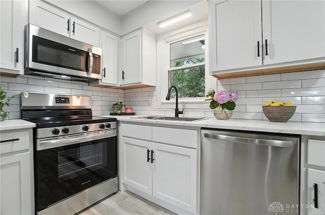 1378 Standish Ave, Riverside, OH 45432 - kitchen with stainless steel appliances, white cabinetry, and tasteful backsplash