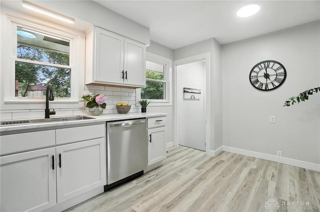 1378 Standish Ave, Riverside, OH 45432 - kitchen featuring dishwasher, light countertops, healthy amount of natural light, and white cabinets