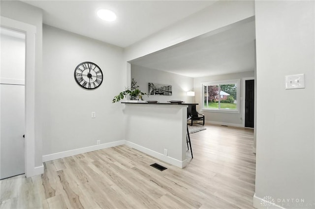 1378 Standish Ave, Riverside, OH 45432 - kitchen with light wood finished floors, a kitchen bar, and a peninsula