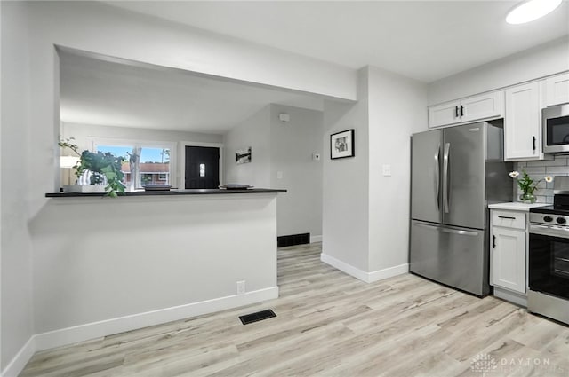 1378 Standish Ave, Riverside, OH 45432 - kitchen with stainless steel appliances, white cabinetry, light wood-type flooring, and tasteful backsplash