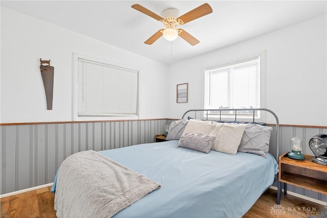 7109 Hancock, Russells Point, OH 43348 - bedroom featuring wood finished floors, wainscoting, and a ceiling fan
