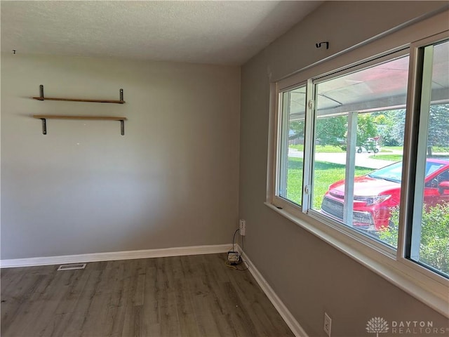 103 W Boitnott Dr, Englewood, OH 45322 - spare room featuring wood finished floors and a textured ceiling