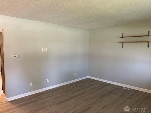 103 W Boitnott Dr, Englewood, OH 45322 - unfurnished room with dark wood-style flooring and a textured ceiling