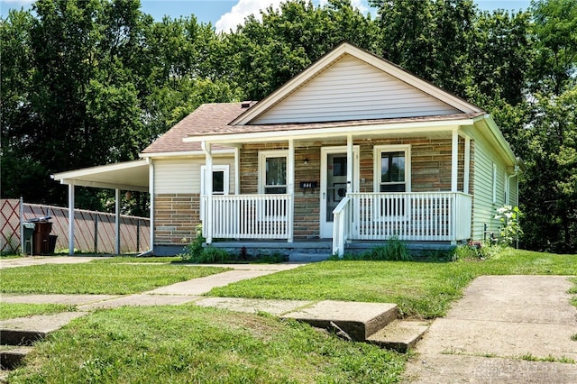 541 E Main St, Xenia, OH 45385 - view of front facade featuring a porch, a front lawn, and roof with shingles
