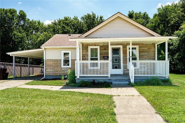 541 E Main St, Xenia, OH 45385 - bungalow-style home with concrete driveway, covered porch, a carport, stone siding, and a shingled roof