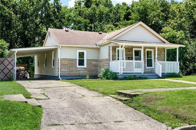 541 E Main St, Xenia, OH 45385 - view of front of property with covered porch, a front lawn, concrete driveway, a carport, and roof with shingles