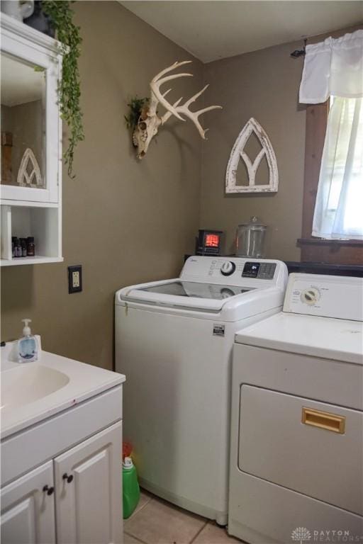 4741 Wolverton Rd, Eaton, OH 45320 - laundry area featuring washer and dryer, cabinet space, and light tile patterned floors