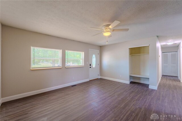1110 Langdale Ave, New Carlisle, OH 45344 - unfurnished living room with dark wood-type flooring, a textured ceiling, and a ceiling fan