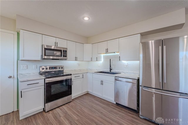 1110 Langdale Ave, New Carlisle, OH 45344 - kitchen featuring appliances with stainless steel finishes, light countertops, white cabinets, and recessed lighting