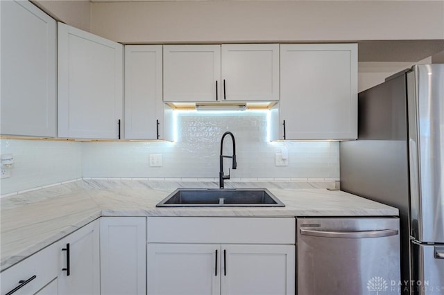 1110 Langdale Ave, New Carlisle, OH 45344 - kitchen with stainless steel appliances, white cabinetry, and tasteful backsplash