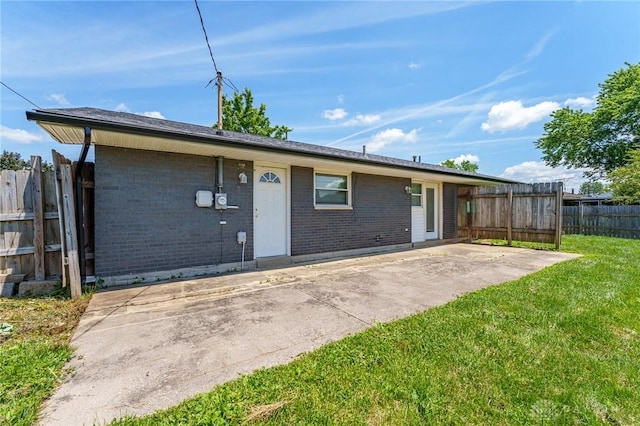 1110 Langdale Ave, New Carlisle, OH 45344 - rear view of property with brick siding and a patio
