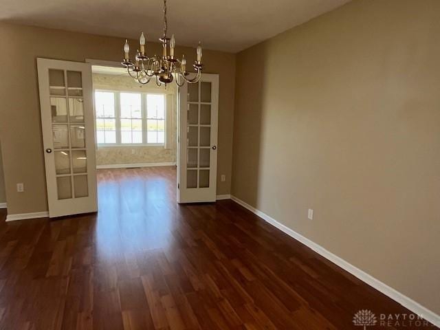 319 Sambor Ct, Piqua, OH 45356 - unfurnished dining area featuring a chandelier and dark wood-style floors