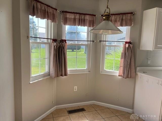 319 Sambor Ct, Piqua, OH 45356 - unfurnished dining area featuring healthy amount of natural light and light tile patterned floors