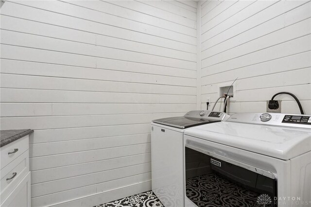 69 Bridge St, Cedarville Twp, OH 45314 - laundry room with washing machine and dryer, wood walls, and cabinet space