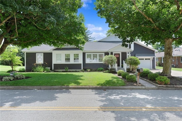 69 Bridge St, Cedarville Twp, OH 45314 - view of front of property with a garage, a front yard, and driveway