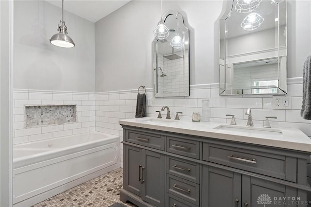 69 Bridge St, Cedarville Twp, OH 45314 - full bathroom featuring double vanity, a bath, tile walls, wainscoting, and tiled shower