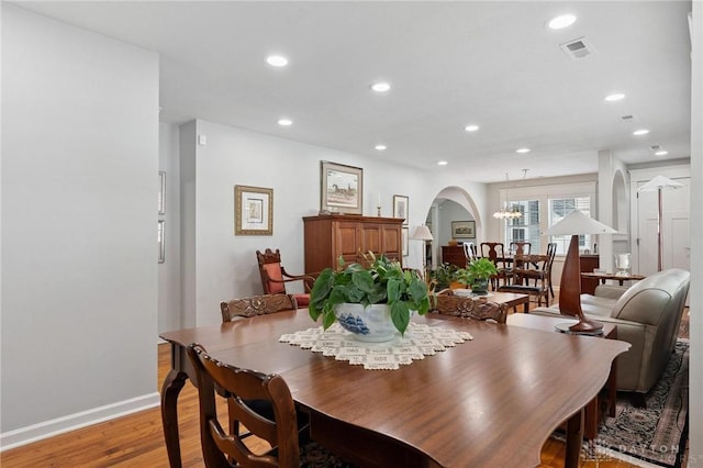 69 Bridge St, Cedarville Twp, OH 45314 - dining space with light wood-style flooring, arched walkways, recessed lighting, and a chandelier