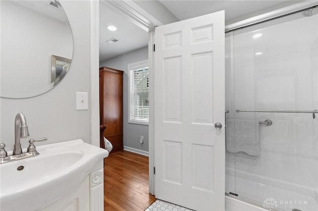 69 Bridge St, Cedarville Twp, OH 45314 - bathroom featuring a stall shower, wood finished floors, vanity, and recessed lighting