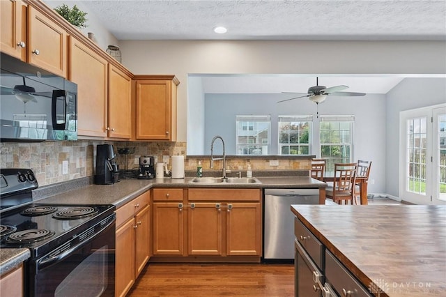 1681 S Branch Rd, Clearcreek Twp, OH 45458 - kitchen featuring black appliances, tasteful backsplash, wood finished floors, ceiling fan, and vaulted ceiling