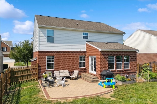 1681 S Branch Rd, Clearcreek Twp, OH 45458 - rear view of property with a patio, a fenced backyard, brick siding, a garden, and an outdoor living space