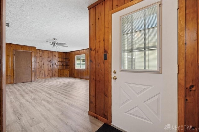 442 Kirkwood Dr, Fairborn, OH 45324 - entryway featuring ceiling fan, wood walls, a textured ceiling, and light wood-type flooring
