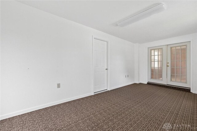 442 Kirkwood Dr, Fairborn, OH 45324 - unfurnished room featuring dark colored carpet and french doors