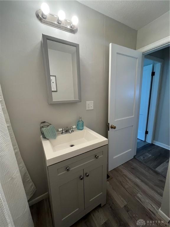 507 Broadway St, Washington Court Hous, OH 43160 - bathroom with wood finished floors, vanity, and a textured ceiling