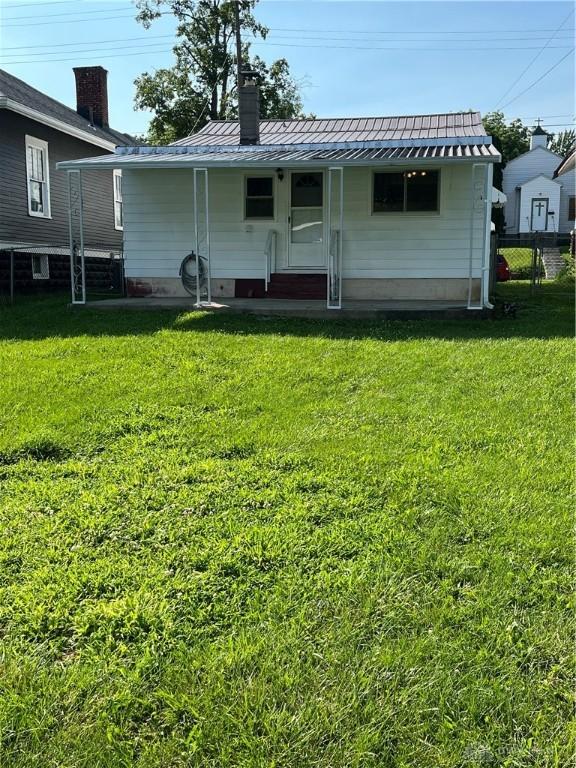 507 Broadway St, Washington Court Hous, OH 43160 - rear view of property featuring a metal roof, a chimney, and a standing seam roof