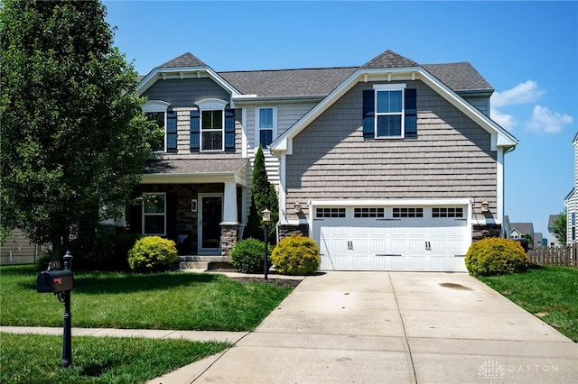 2933 E Ambrosia Ln, Xenia, OH 45385 - craftsman inspired home with a front yard, an attached garage, driveway, stone siding, and a shingled roof