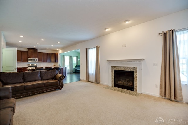 2933 E Ambrosia Ln, Xenia, OH 45385 - living room with plenty of natural light, light carpet, recessed lighting, and a high end fireplace